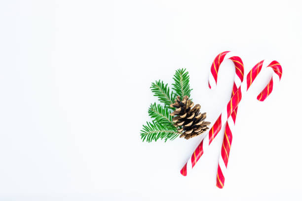 istock Holiday ornament with candy cane, tree branches and pine cone. 1278639502