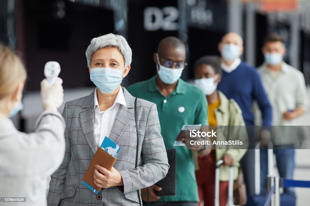 People testing at the airport Group of people in mask standing in a row and testing they are at the airport Airport Stock Photo
