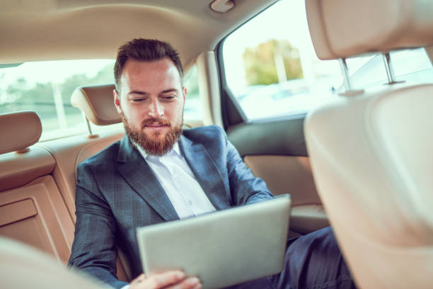 istock Smiling Male Businessman Working On Digital Tablet While Traveling 1278641722