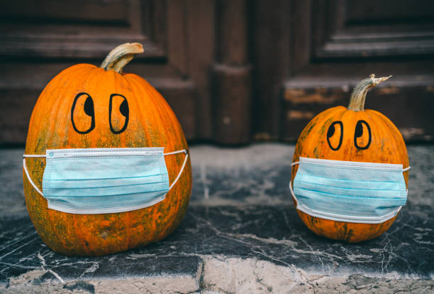 istock Halloween pumpkins with protective medical masks 1278642018