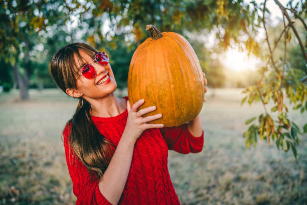 istock Woman with pumpkin for Halloween 1278643238