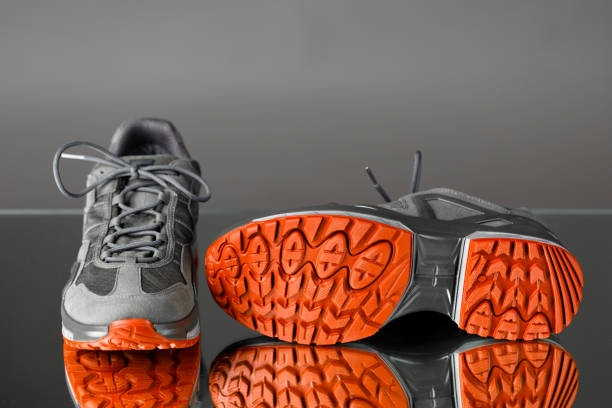 istock trekking sneakers with red sole, gray background 1278643358