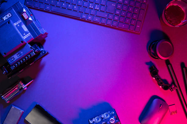 istock Overhead view of computer parts with coffee and video camera on illuminated table 1278643383