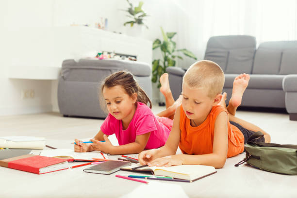 istock Two cute children draws on floor at home 1278643949