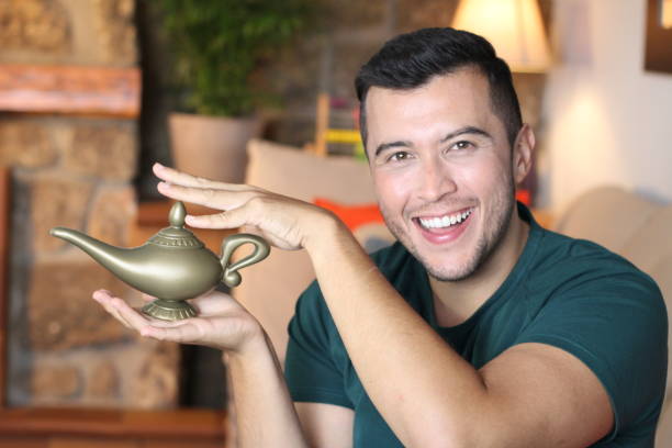 Young ethnic man holding genie lamp.