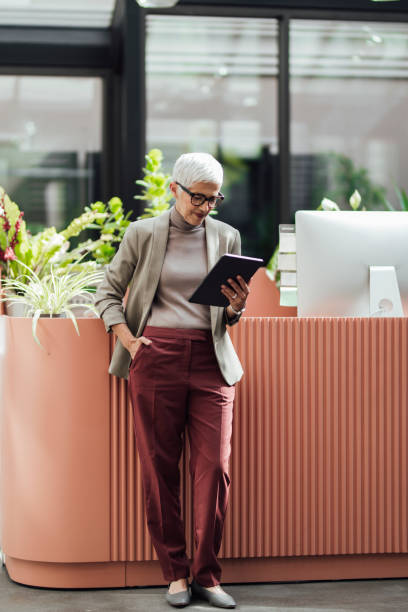 istock Happy Senior Businesswoman Using a Digital Tablet at Work 1278647020