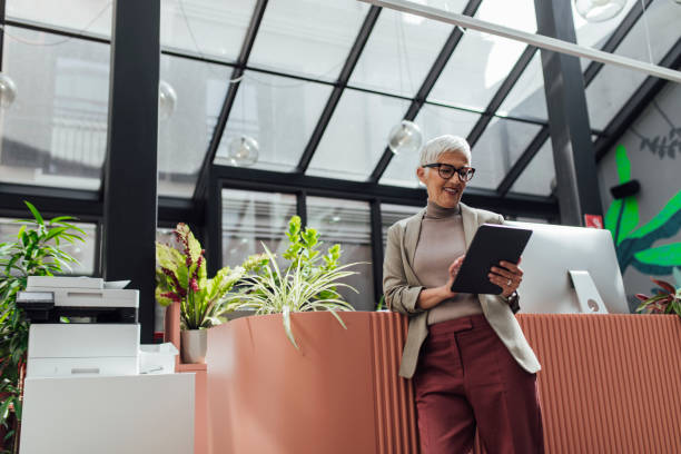 istock Happy Senior Businesswoman Using a Digital Tablet at Work 1278647024
