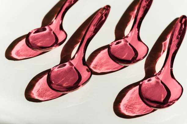 istock Disposable plastic pink spoons on white background with contrasting shadows 1278647660