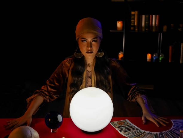 istock beautiful young asian professional fortune teller using divine power forecast to the future luck using crystal ball 1278647743