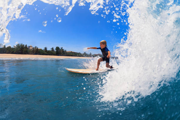 istock Young surfer learn to ride on surfboard on sea waves 1278647884
