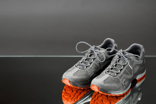 istock trekking sneakers with red sole, gray background with copy-space 1278647958