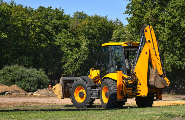 Construction machinery tractor with bucket and excavator stock photo
