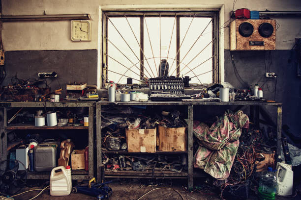Table and various tools in an old garage workshop equipment, vintage effect film.