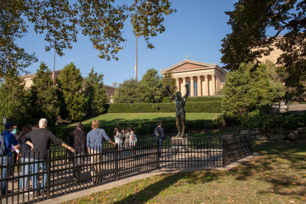 People at the Rocky Balboa statue stock photo