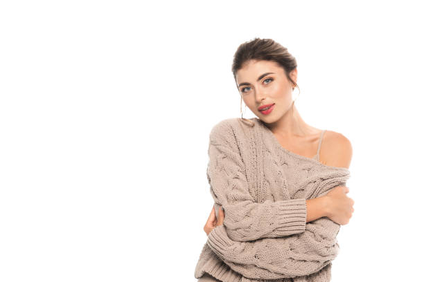 istock trendy woman in openwork sweater looking at camera while hugging herself isolated on white 1278653641