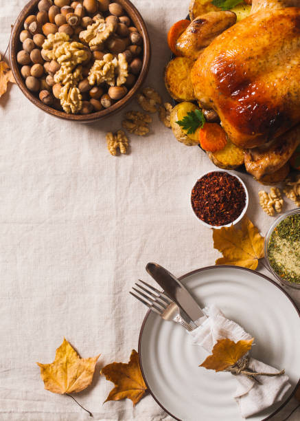 istock Fall thanksgiving table with roasting chicken or turkey, nuts, pie, pumkins and other food on light 1278655423
