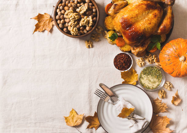 istock Fall thanksgiving table with roasting chicken or turkey, nuts, pie, pumkins and other food on light 1278655427