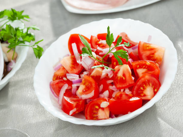 istock Fresh salad with tomatoes and chopped onion 1278657040