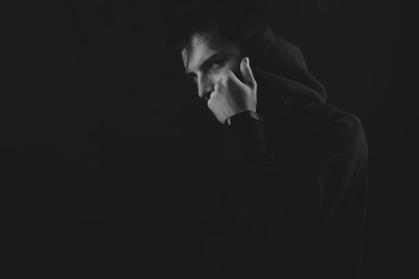 istock Young man in the hood posing in the dark 1278657259