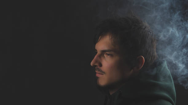 istock Young man in the dark. male portrait 1278657312