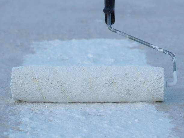 istock Close-up. Applying a waterproof coating to the roof with a roller. 1278658170