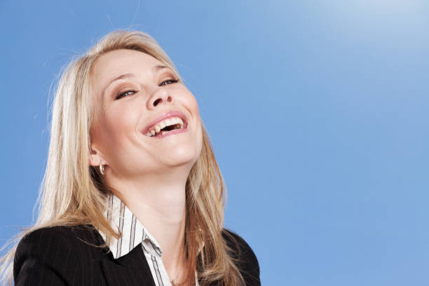istock Beautiful young blonde woman throws her head back and laughs 1278659443