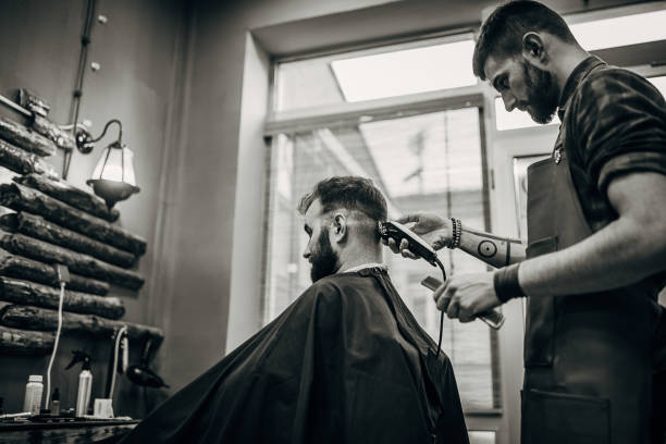 istock One man getting haircut by barber with electric razor 1278659465