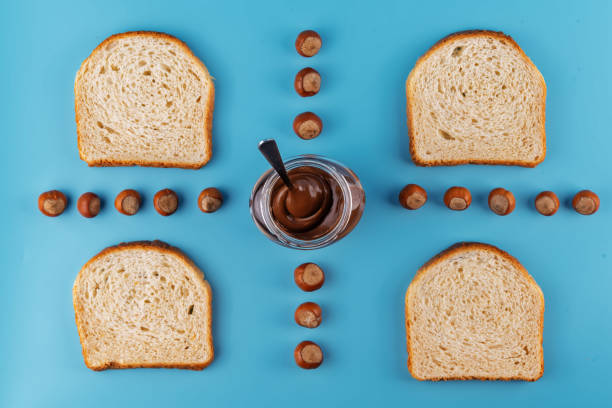 Chocolate hazelnut pasta in a jar on  a blue background