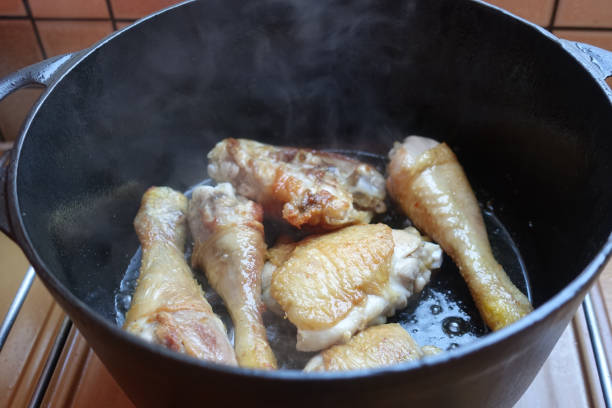 istock Chicken thighs being cooked in a cast iron casserole dish 1278661210