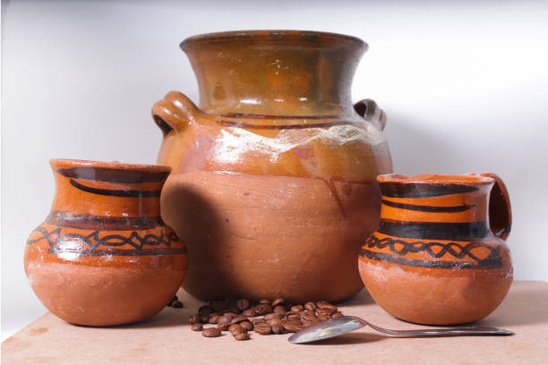 istock Pot and mud jars next to natural coffee beans 1278661882