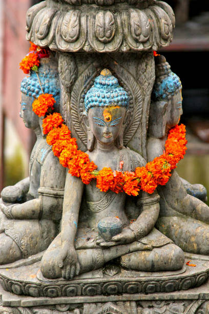 istock A statue of Buddha decorated with orange flowers 1278662801