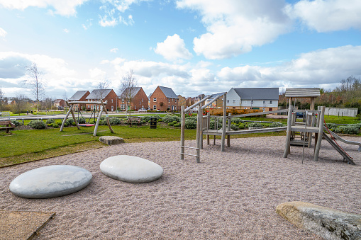 Newly built development residential area children outdoor kid playground and park in England