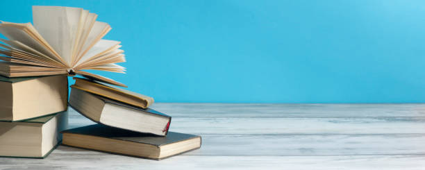 istock Open book, hardback books on wooden table. Back to school. Copy space. 1278665921
