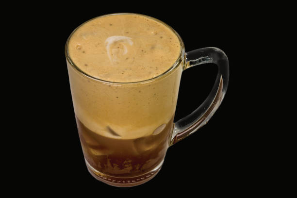 cold expressed Delicious espresso freddo with ice cubes in a glass, isolated on black background. freddo cappuccino stock pictures, royalty-free photos & images