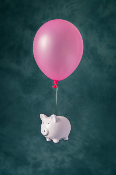 istock Piggy bank flying on balloon 1278667287