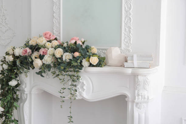 istock white interior flowers. white mantelpiece with flowers 1278667339