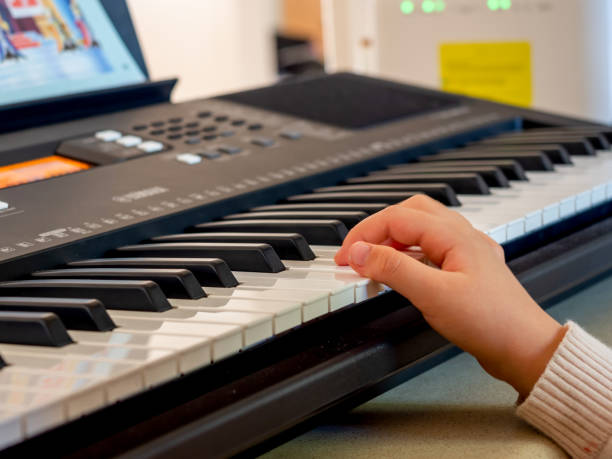 Girls hand on Electric Keyboard Piano