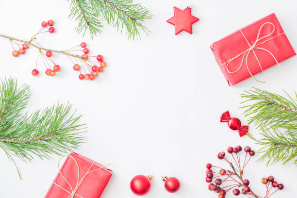 istock Flat lay frame with red christmas decoration, pine branches and gift box on a white background 1278667699