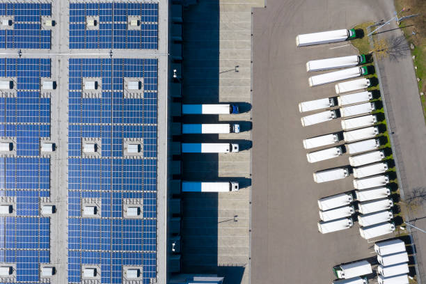 istock Aerial View of Trucks Loading at Logistic Center, Distribution Warehouse with Solar Photovoltaic Panels 1278668416