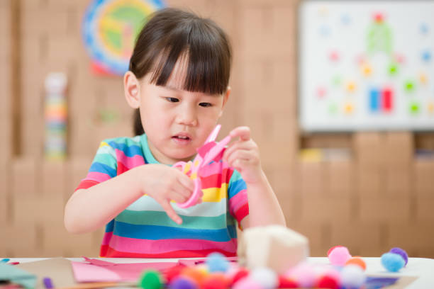 istock young girl using scissors cutting paper for making craft for home schooling 1278668515