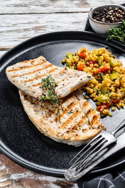 istock Roast Turkey meat Steaks with quinoa. White background. Top view 1278668675