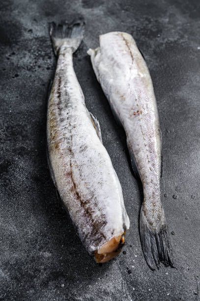 istock Raw Pollock fish ready to cook. Black background. Top view 1278668780