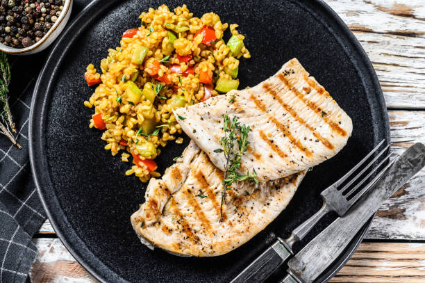 istock Grilled Turkey breast Steaks with quinoa salad. White background. Top view 1278669438