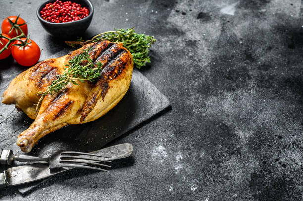 istock Baked whole farm chicken. Black background. Top view. Copy space 1278670925