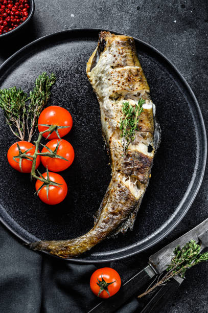 istock Baked pollock cooked in a savory marinade.  Black background. Top view 1278670997