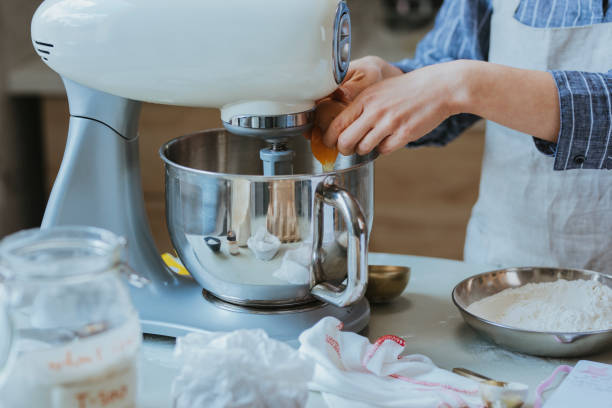 istock Making Pastry: Hands of an Anonymous Woman Adding Eggs into the Mixing Bowl 1278671175