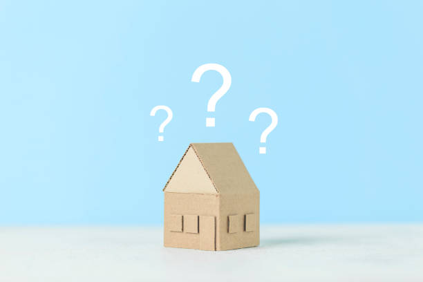 istock A question on a small house, a magnifying glass examines the building. Assistance in choosing and buying real estate 1278671489