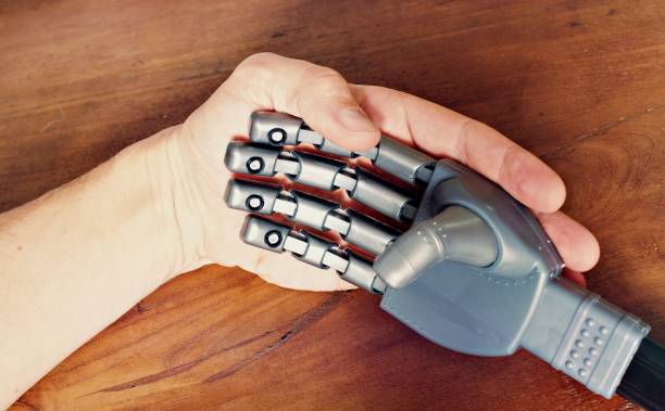 istock Close up of a human hand with a robotic hand 1278671564