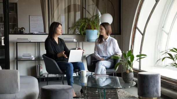 istock Focused young mixed race female colleagues discussing project. 1278673150