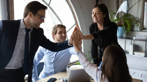 istock Happy motivated multiracial employees giving high five. 1278673187